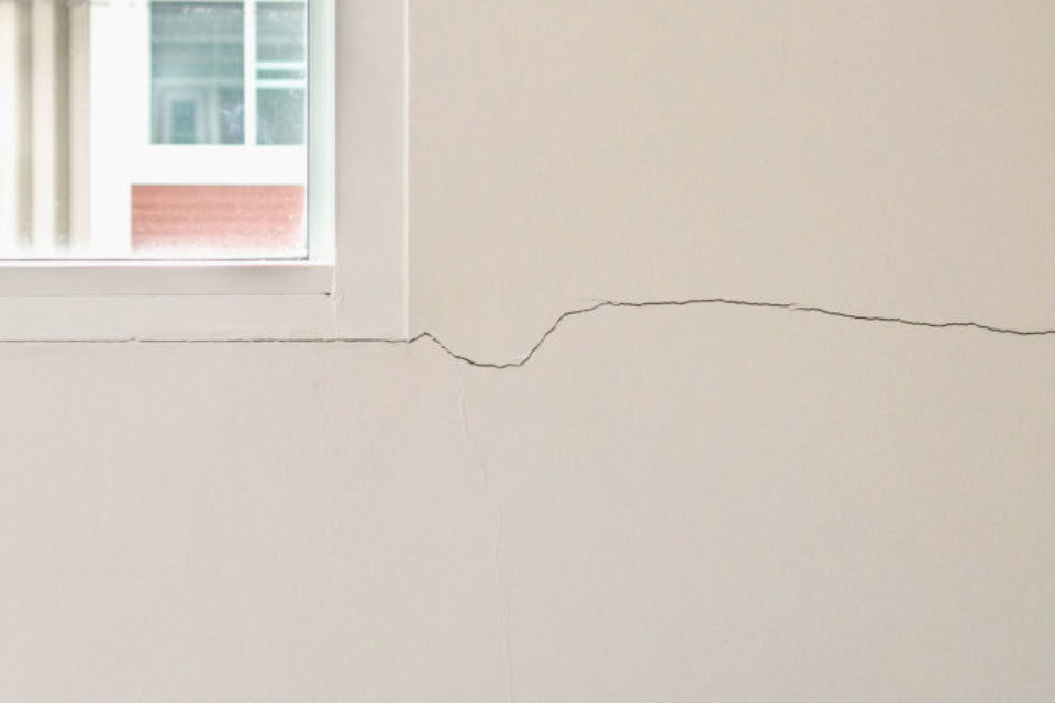 Repair cracks in walls before plastering