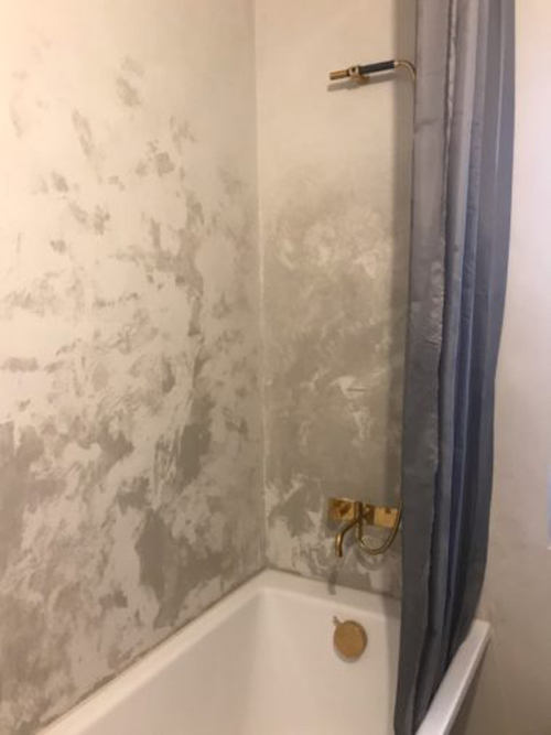 A stucco on a shower wall is completely ruined by water because of bad waterproofing